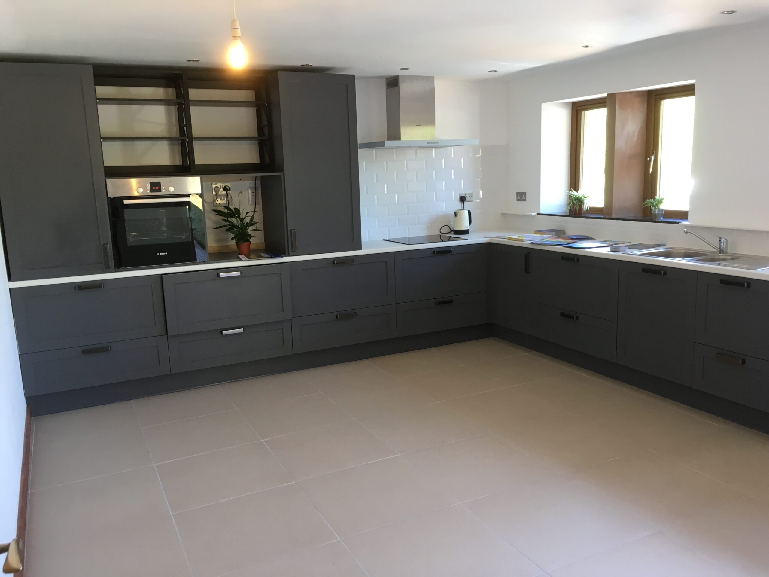 Kitchen made with flood resilient materials with raised oven, fridge and freezer.