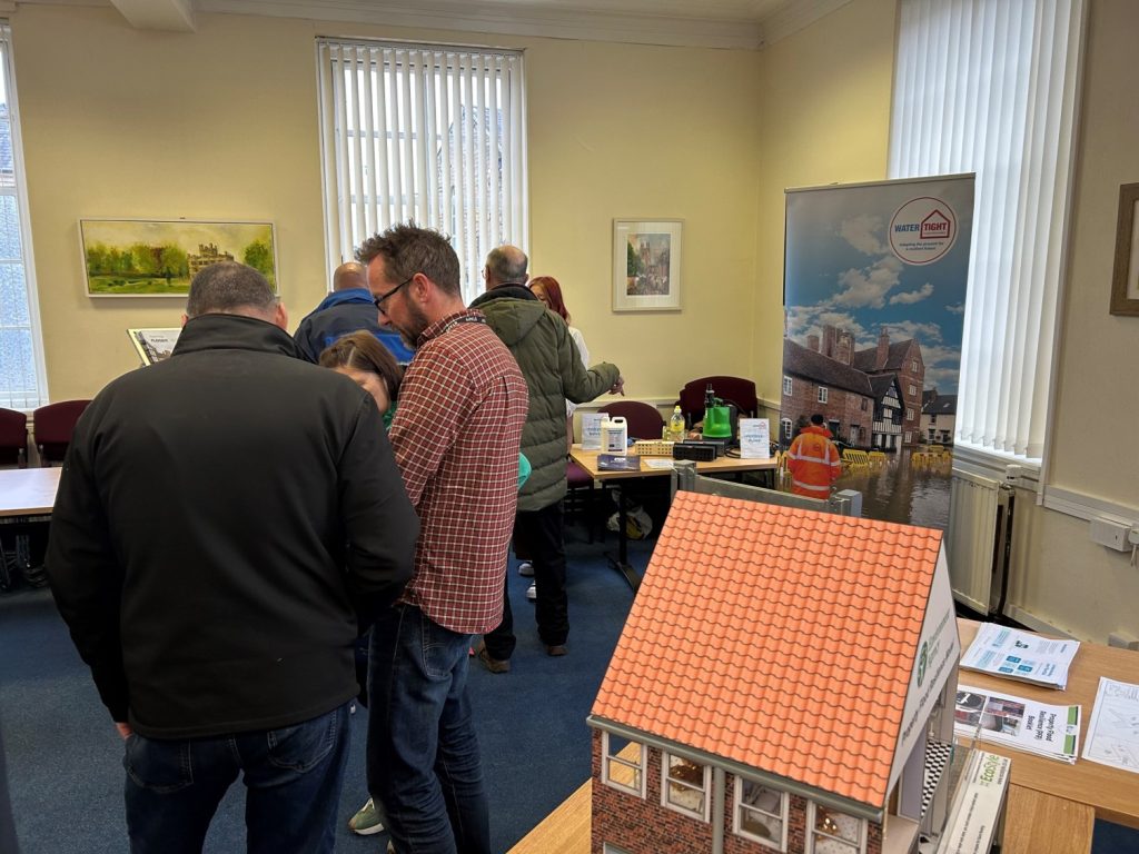 A photo showing members of the public in the community room at Padiham Town Hall talking to Environment Agency and Partner staff members.